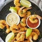 Coconut Prawns on black plate with 2 dipping sauces