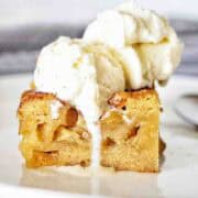 A blondie with vanilla ice cream on top on a white plate.