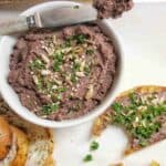 Chicken Pate in white bowl with butter knife across the top