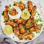 Dry Rub Air Fryer Chicken Wings with yogurt sauce on white plate