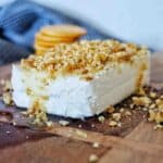 Honey Walnut Cream Cheese on timber board with crackers behind