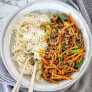 Beef mince stir fry with vegetables and rice in white bowl.