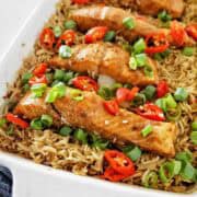 Cooked salmon and rice in white casserole dish.