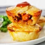 Two small pieces stacked on top of each other with sauce.