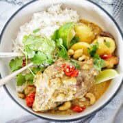 Lamb shanks in bowl with potatoes and coconut rice.