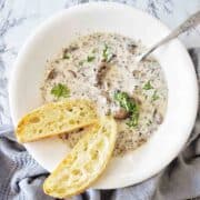 Slow Cooker Mushroom Soup in white bowl with toasted bread on the left