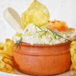 Dip in small bowl with chips and dill.