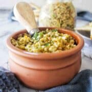 Spicy Olive Tapenade in a small brown serving bowl with utensil