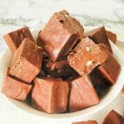 Chopped pieces of toblerone fudge in small white bowl.