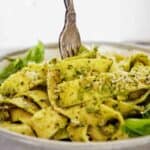 Fork on a slight angel being twirled in bowl of pappardelle.